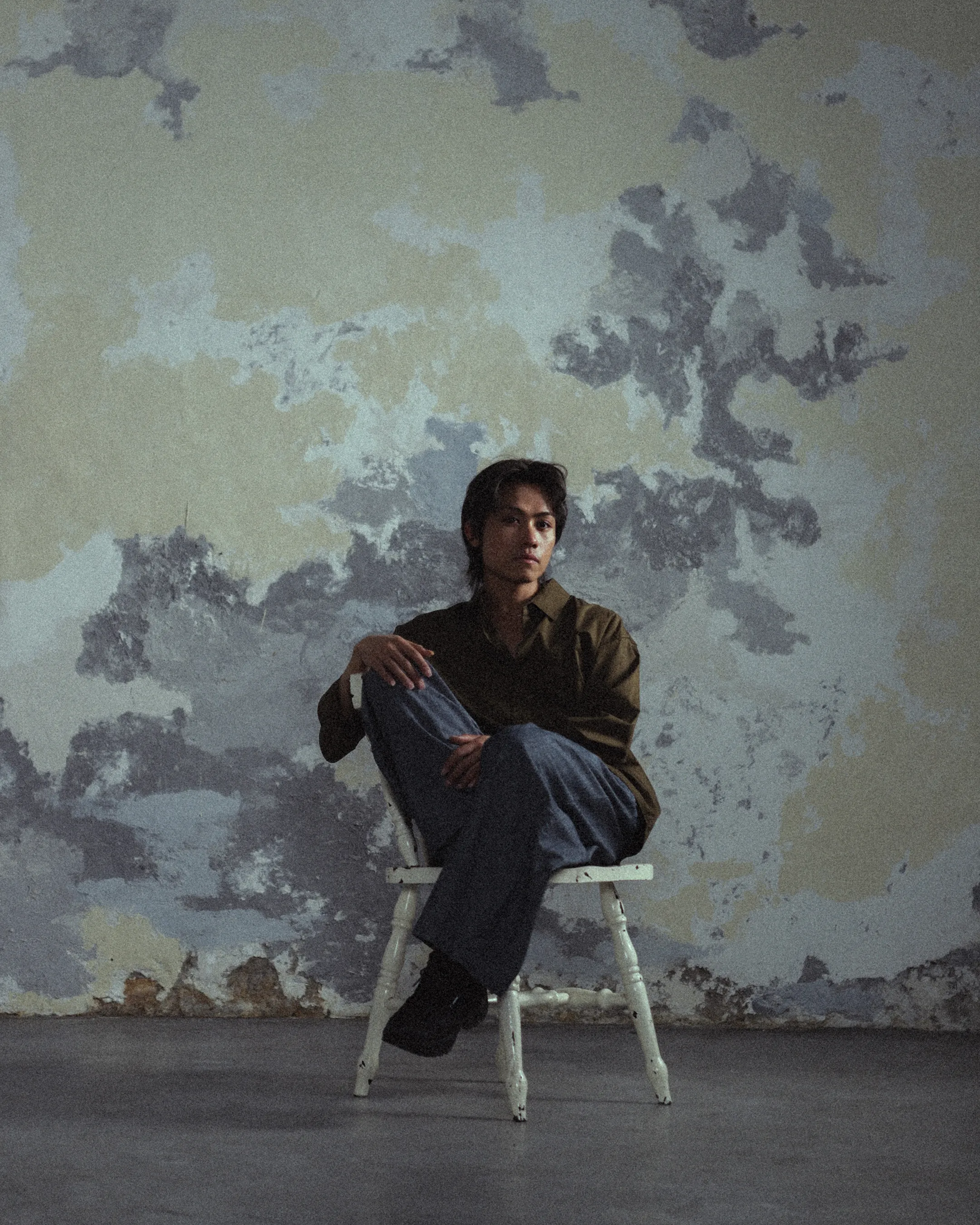 Tyler La, seated, photographed by Đông Trần.